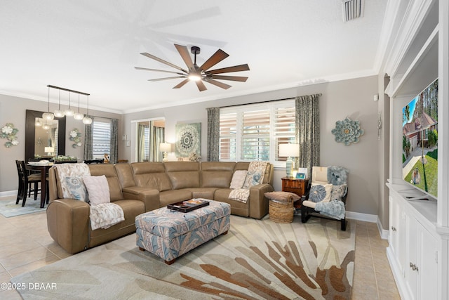 living room featuring light tile patterned flooring, a healthy amount of sunlight, and crown molding