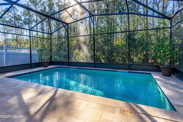 view of swimming pool featuring a lanai and a patio