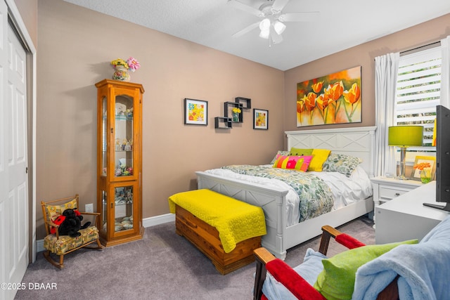 carpeted bedroom featuring a closet and ceiling fan