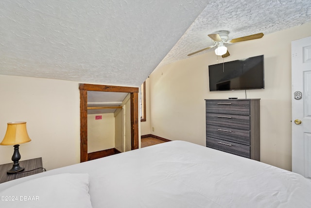 bedroom with a textured ceiling and ceiling fan