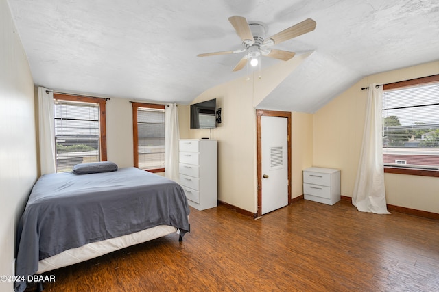 bedroom with multiple windows, wood-type flooring, lofted ceiling, and ceiling fan