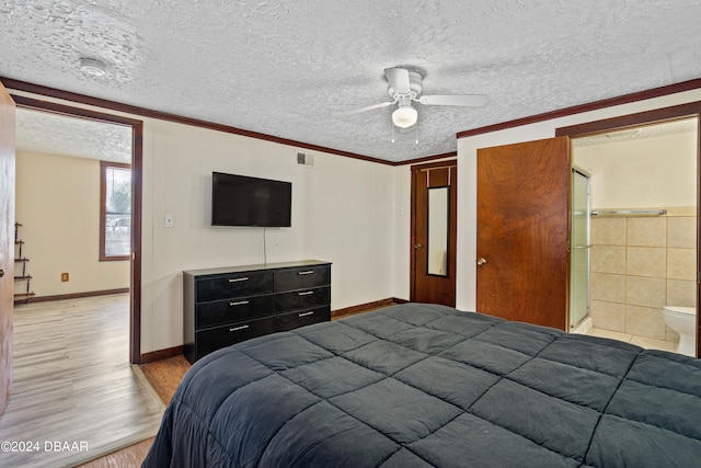 bedroom with ensuite bath, crown molding, a textured ceiling, light hardwood / wood-style floors, and ceiling fan