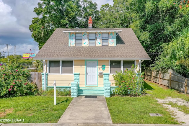 bungalow-style house with a front lawn