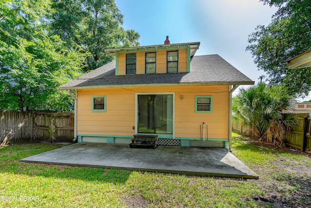 back of house with a patio and a yard