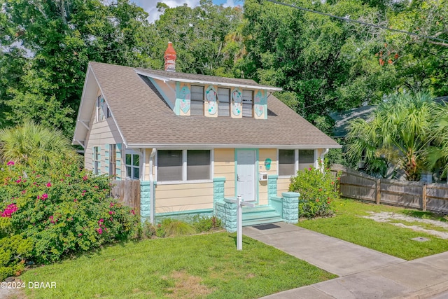 bungalow-style house with a front yard