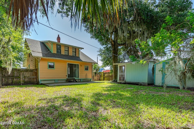 back of property featuring a patio area and a yard