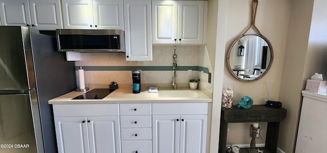 2700 N Atlantic Ave Unit 905, Daytona Beach, FL 32118 - kitchen featuring stainless steel appliances, backsplash, white cabinetry, light countertops, and a sink
