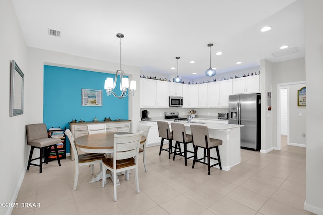 914 Attitude Ave, Daytona Beach, FL 32124 - dining room with recessed lighting, an inviting chandelier, visible vents, light tile patterned floors, and baseboards