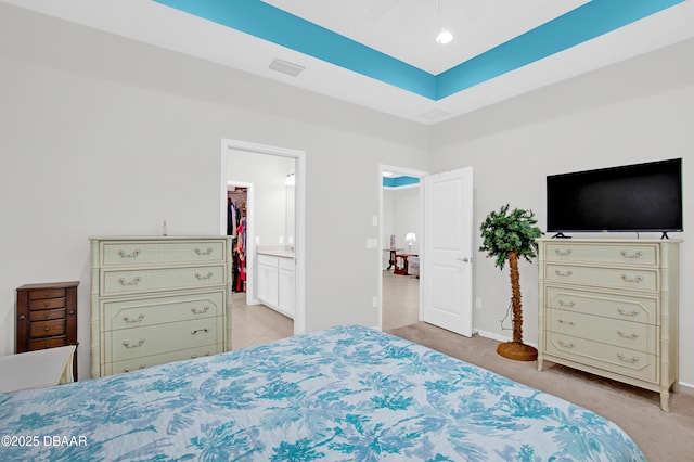 914 Attitude Ave, Daytona Beach, FL 32124 - bedroom with a walk in closet, connected bathroom, light colored carpet, baseboards, and visible vents