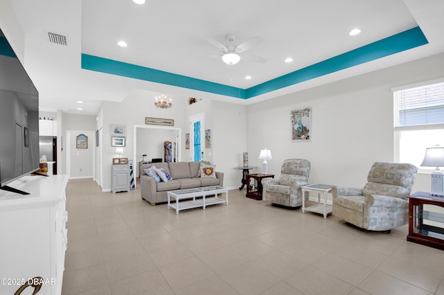 914 Attitude Ave, Daytona Beach, FL 32124 - living room featuring a tray ceiling, light tile patterned floors, recessed lighting, and ceiling fan with notable chandelier