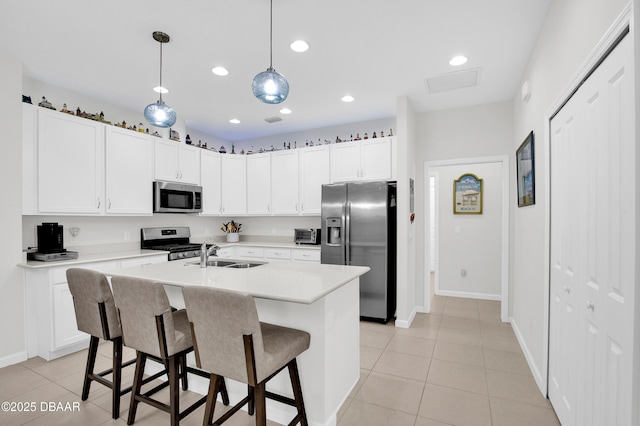 914 Attitude Ave, Daytona Beach, FL 32124 - kitchen featuring a sink, light tile patterned floors, light countertops, appliances with stainless steel finishes, and recessed lighting