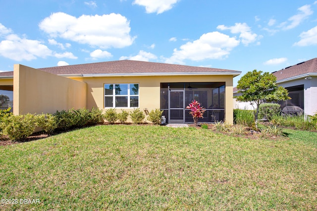914 Attitude Ave, Daytona Beach, FL 32124 - back of property featuring a yard, a sunroom, and stucco siding