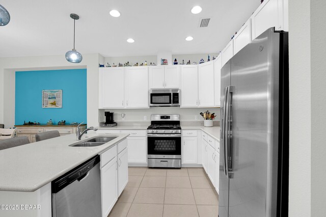 914 Attitude Ave, Daytona Beach, FL 32124 - kitchen with light countertops, appliances with stainless steel finishes, light tile patterned floors, and a sink