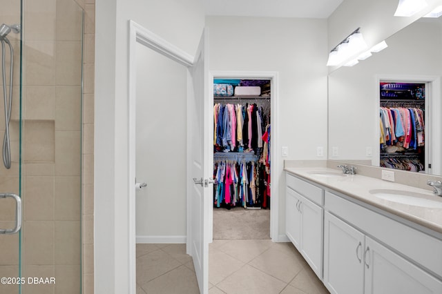 914 Attitude Ave, Daytona Beach, FL 32124 - full bathroom featuring a walk in closet, tile patterned flooring, a sink, and a stall shower