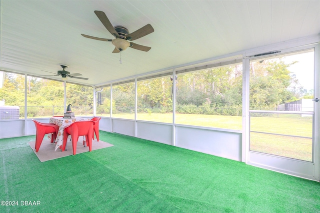 unfurnished sunroom featuring ceiling fan