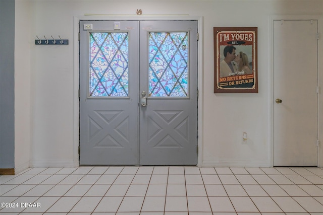 entryway featuring french doors and light tile patterned flooring