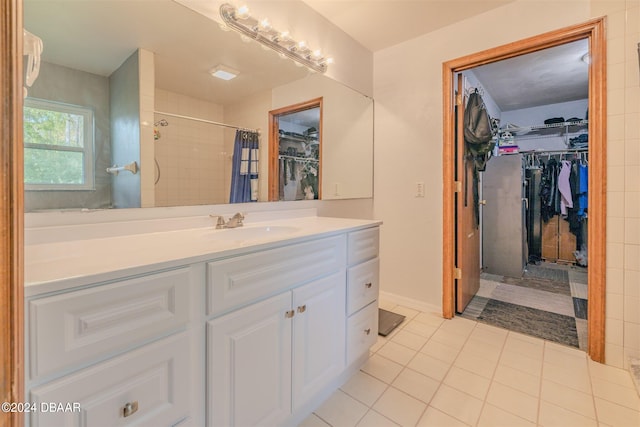 bathroom with a shower with curtain, vanity, and tile patterned floors