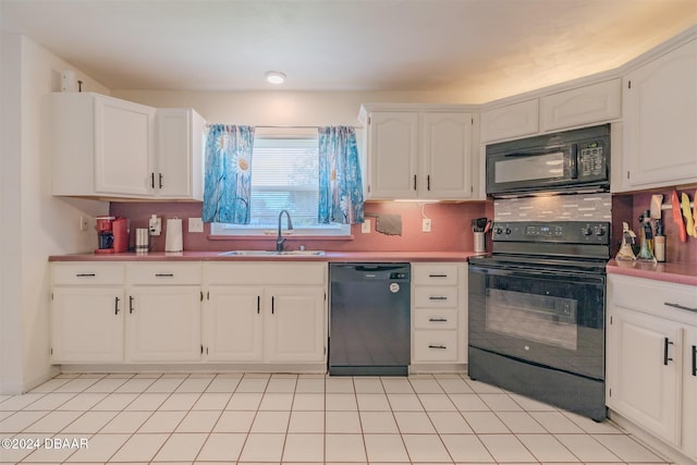 kitchen with white cabinetry, sink, black appliances, and tasteful backsplash