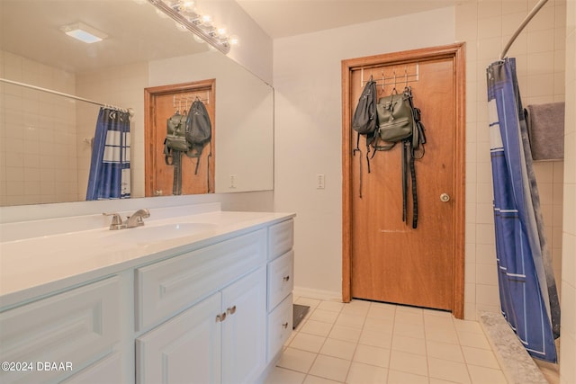 bathroom featuring vanity, tile patterned flooring, and curtained shower