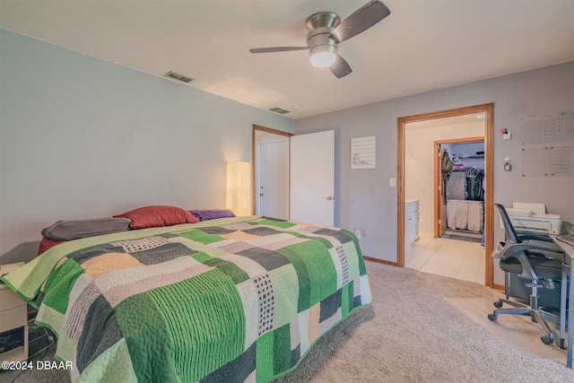 carpeted bedroom featuring ceiling fan, a walk in closet, and a closet