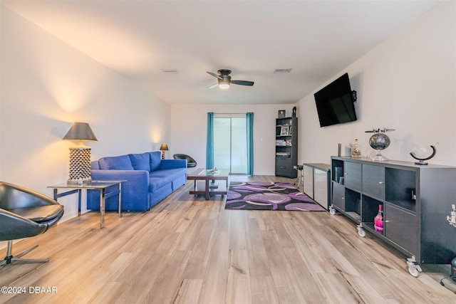 living room featuring light wood-type flooring and ceiling fan