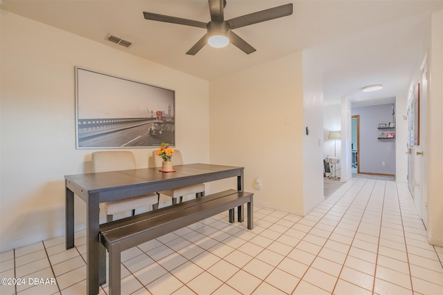 tiled dining area with ceiling fan