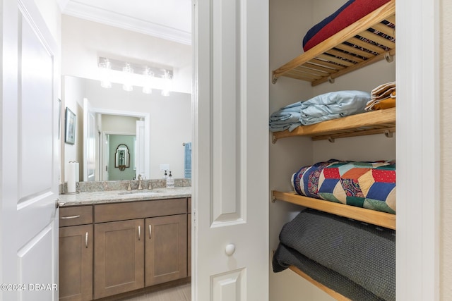 bathroom featuring vanity and ornamental molding