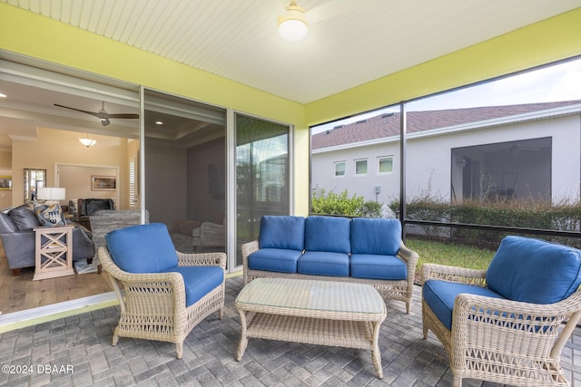 sunroom / solarium featuring ceiling fan