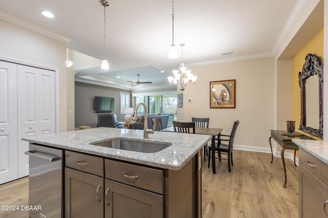 kitchen with light stone countertops, ceiling fan with notable chandelier, sink, decorative light fixtures, and light hardwood / wood-style flooring