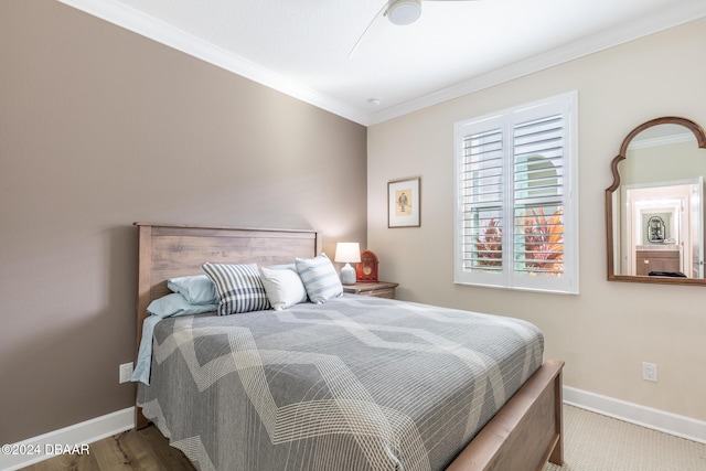 bedroom featuring wood-type flooring and crown molding