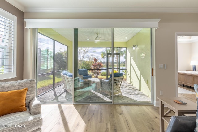 doorway to outside featuring hardwood / wood-style flooring, plenty of natural light, and ornamental molding