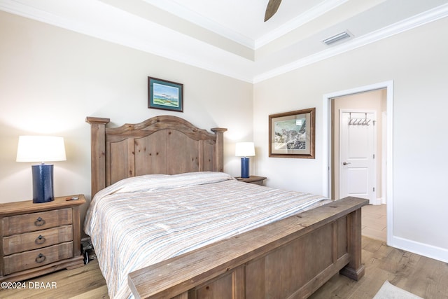 bedroom with ceiling fan, light hardwood / wood-style floors, and ornamental molding