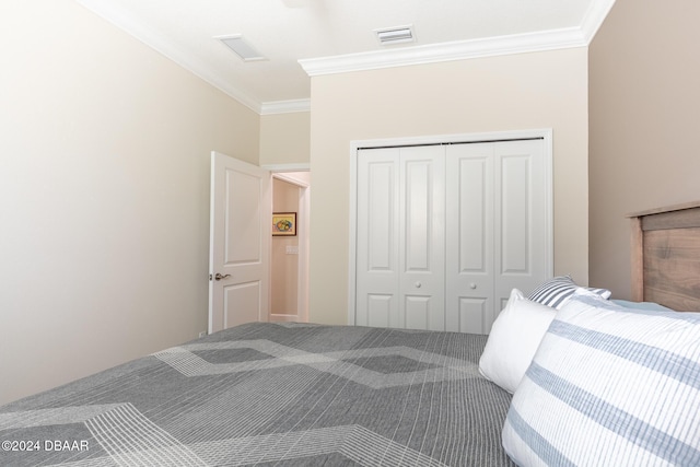 carpeted bedroom with a closet and ornamental molding