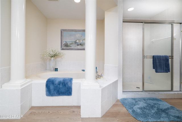 bathroom with wood-type flooring and separate shower and tub