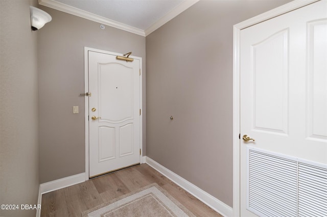 doorway to outside featuring light wood-type flooring and crown molding