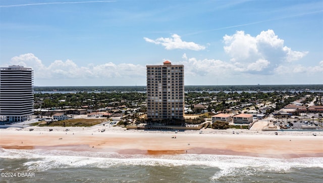 drone / aerial view with a water view and a beach view