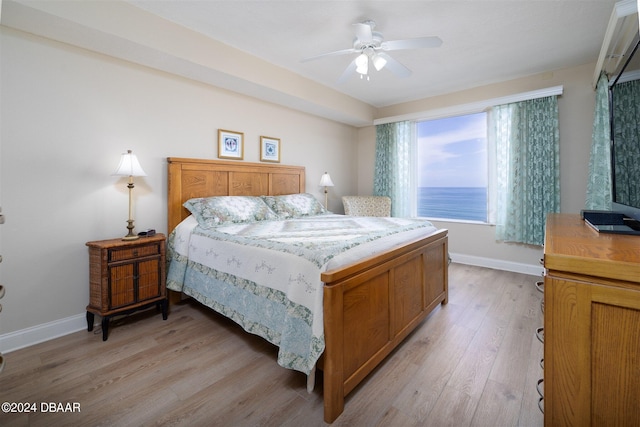 bedroom with light hardwood / wood-style floors and ceiling fan