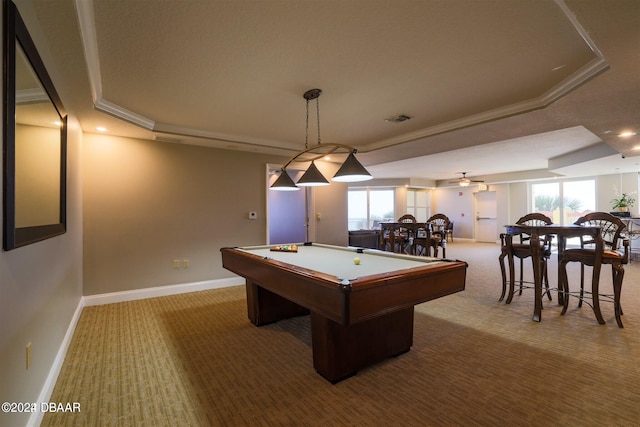 recreation room with a wealth of natural light, a raised ceiling, carpet, and ornamental molding