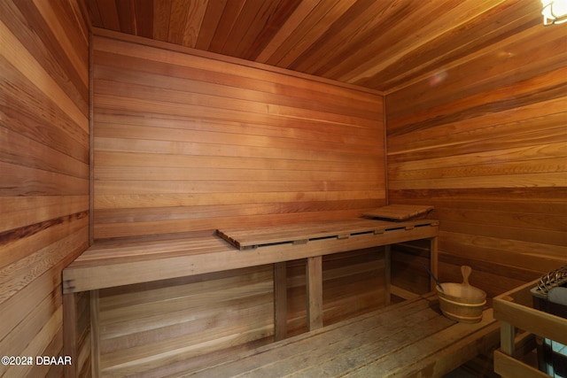 view of sauna / steam room featuring wooden walls and wood ceiling