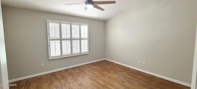 unfurnished room with hardwood / wood-style flooring and ceiling fan