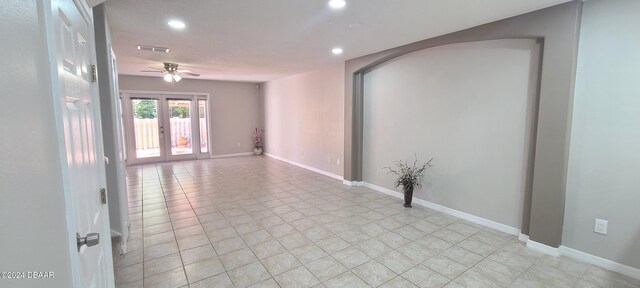 hallway with french doors and light tile patterned floors