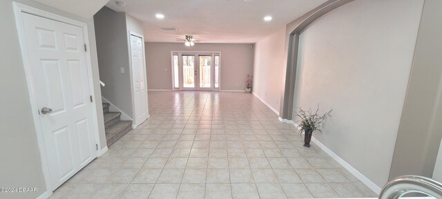 tiled empty room with ceiling fan