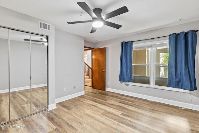 12 Big Buck Trl, Ormond Beach, FL 32174 - unfurnished bedroom with wood finished floors, a closet, and a ceiling fan