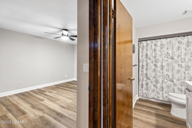 12 Big Buck Trl, Ormond Beach, FL 32174 - bathroom with wood finished floors, ceiling fan, vanity, and a shower with shower curtain