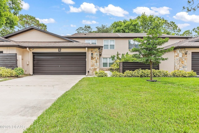 12 Big Buck Trl, Ormond Beach, FL 32174 - view of front facade with stone siding, a garage, a front lawn, driveway, and stucco siding