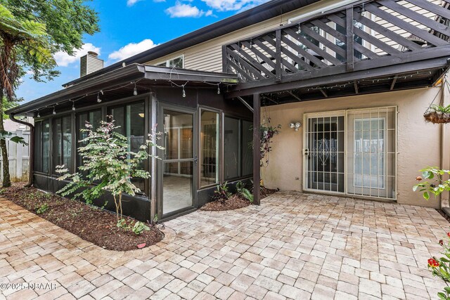 12 Big Buck Trl, Ormond Beach, FL 32174 - view of patio / terrace featuring a sunroom and a wooden deck