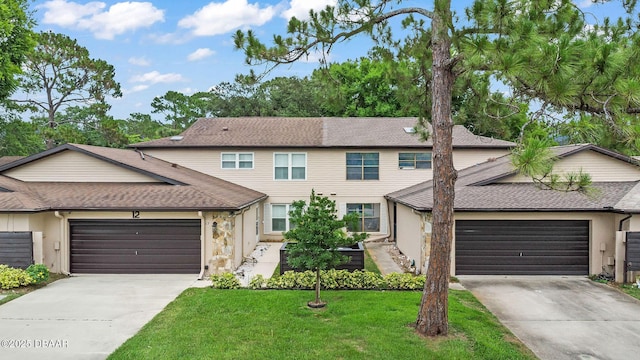 12 Big Buck Trl, Ormond Beach, FL 32174 - multi unit property with driveway, a garage, a front lawn, and a shingled roof