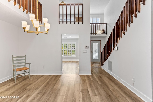 12 Big Buck Trl, Ormond Beach, FL 32174 - foyer entrance featuring a chandelier, wood finished floors, stairs, and a high ceiling