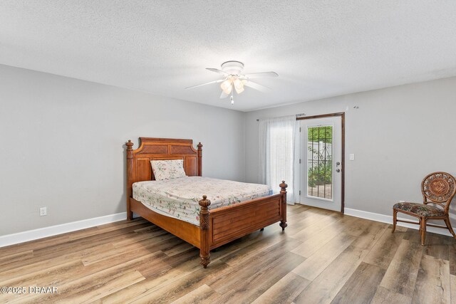 12 Big Buck Trl, Ormond Beach, FL 32174 - bedroom with access to outside, light wood-style flooring, ceiling fan, and a textured ceiling