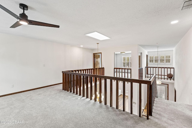 12 Big Buck Trl, Ormond Beach, FL 32174 - corridor featuring an upstairs landing, carpet, a textured ceiling, and a chandelier